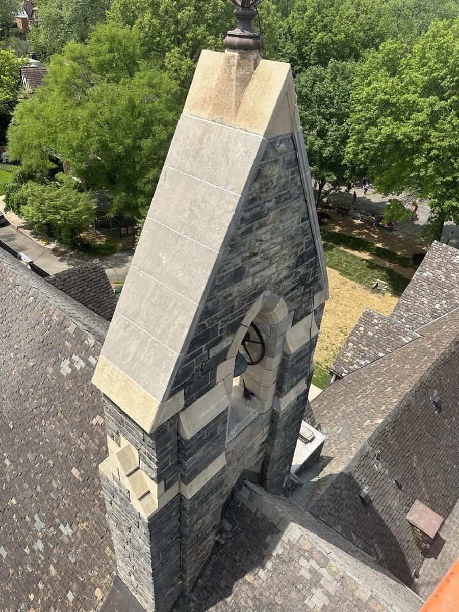 Stone church bell tower with new stone caps