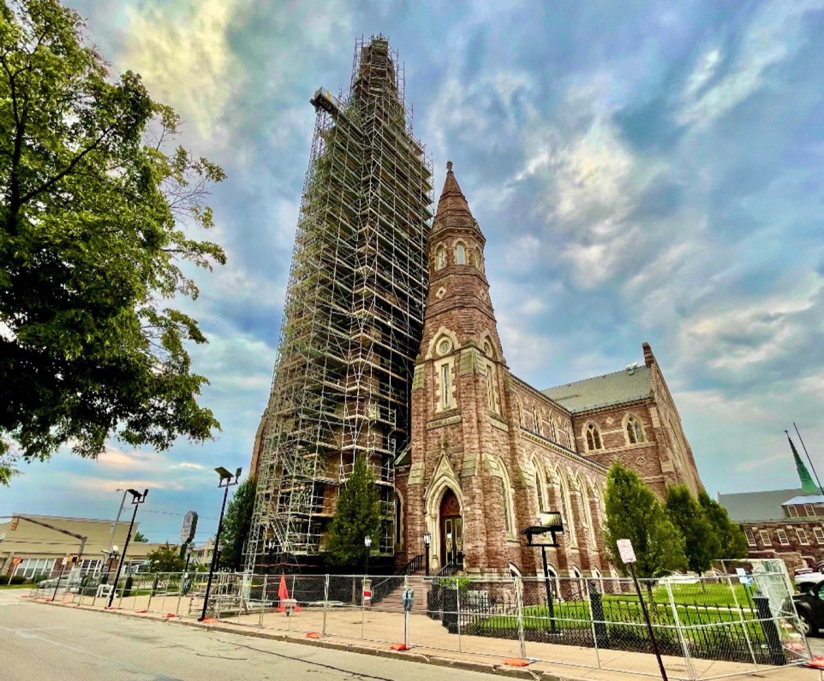 Alex Restoration crew restoring a historic church spire under full scaffolding